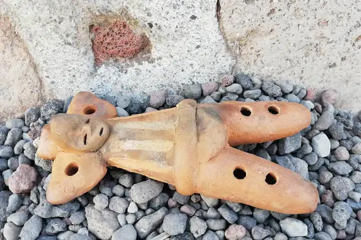 Clayflute in the shape of a person - with holes on clay legs