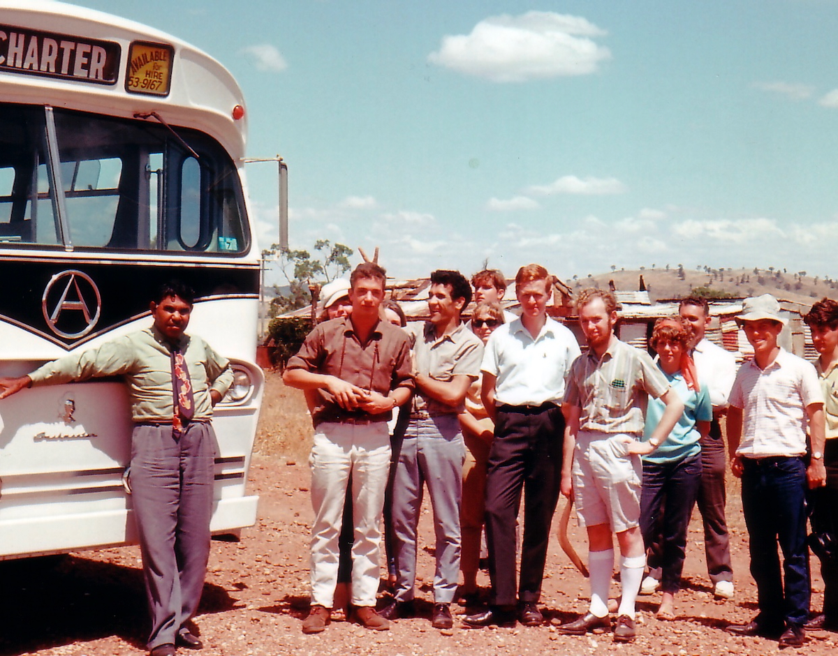 Group of people standing outside bus