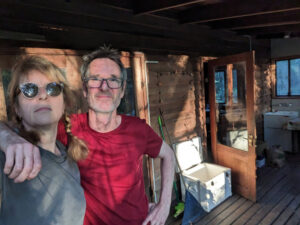 Woman and man with arms around each other standing on balcony