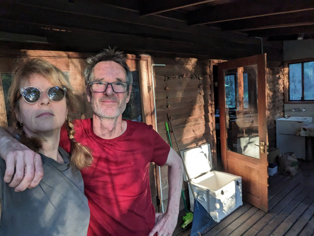 Woman and man with arms around each other standing on balcony
