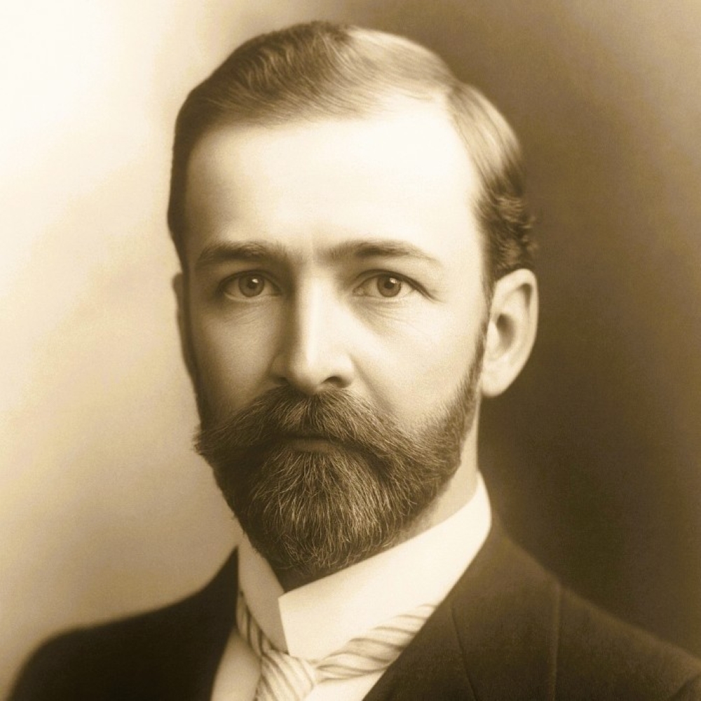 A black and white image of a young bearded man